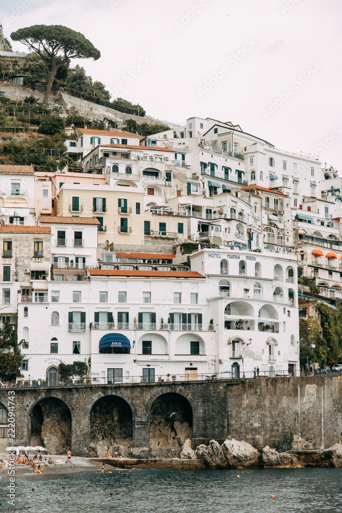 Amalfi coast in Italy, the most beautiful city. Streets and old architecture, narrow passages, shops and cafes. View from the sea and above