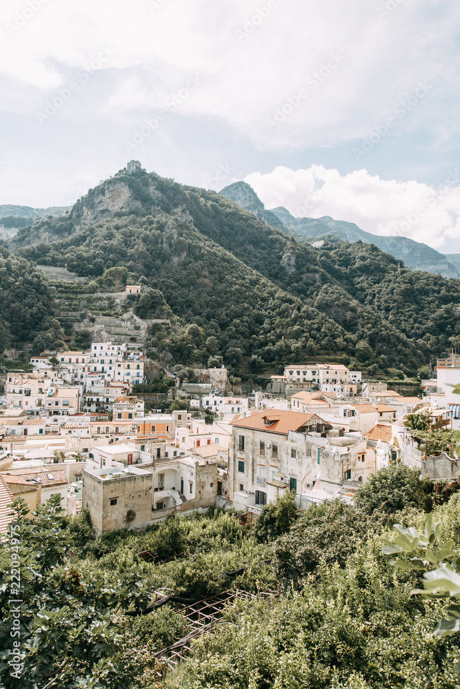 The Amalfi coast and the mountain slopes with plantations of lemons. Panoramic view of the city and nature of Italy. Evening landscapes and winding roads