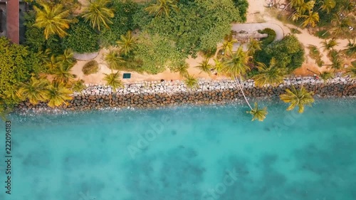 crystal blue water waves hitting the rocks at the beach of Palawan Islands / Santosa Island in Singapur. photo