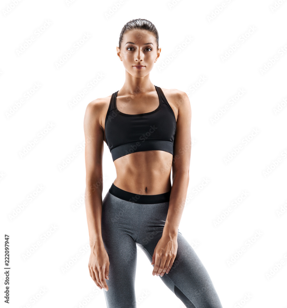 Young slim girl in sportswear isolated on white background. Concept of healthy life and natural balance between body and mental development Young slim girl in sportswear isolated on white background. Concept of healthy life and natural balance between body and mental development