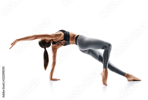 Silhouette of slim girl practicing yoga isolated on white background. Concept of healthy life and natural balance between body and mental development. Full length