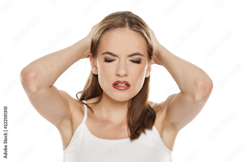 Beautiful girl with headache on white background