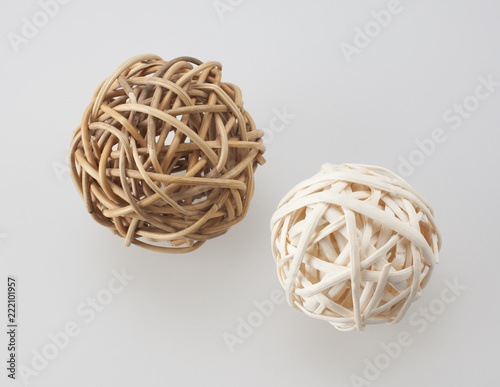 wicker balls, white and beige, on white background, composition.