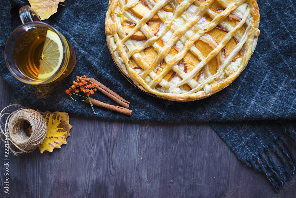 Autumn concept. Pie with Peaches Autumn Foliage Tea Honey On a wooden background