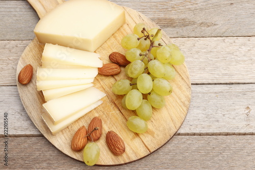 Cheese, grapes and almonds on a board
