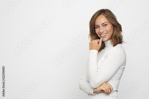 Portrait of  young smiling woman looks in camera
