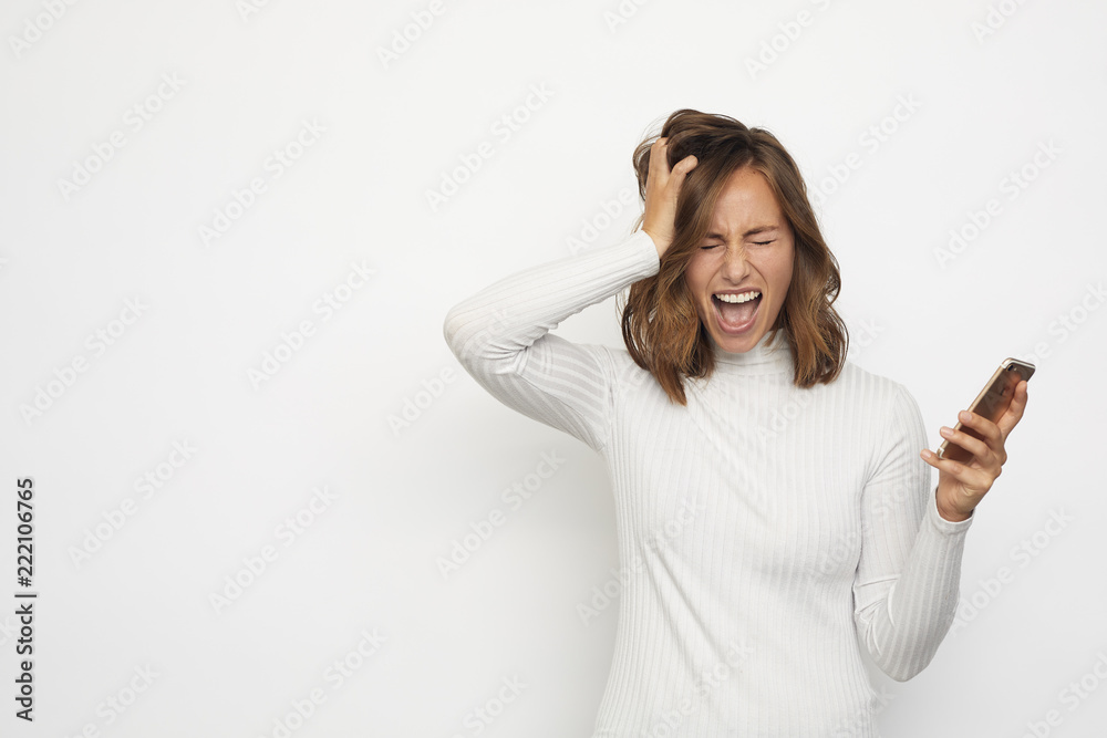 portrait of young woman with a phone is really frustrated and upset