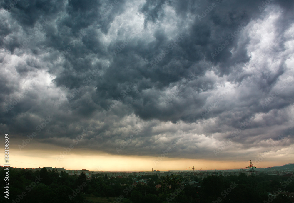 Stormy gray clouds in sky above the city, rainy weather Stormy gray clouds in sky above the city, rainy weather