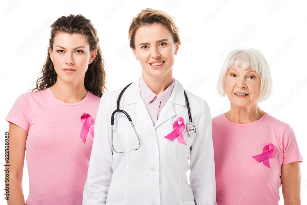 doctor and women with breast cancer awareness ribbons smiling at camera isolated on white doctor and women with breast cancer awareness ribbons smiling at camera isolated on white