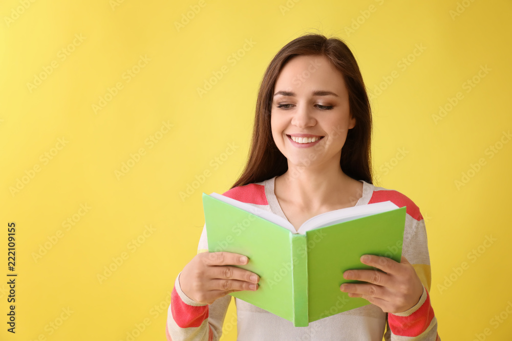 Young woman with book on color background Young woman with book on color background