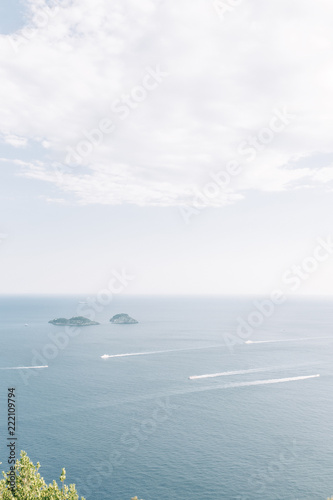 Fototapeta Naklejka Na Ścianę i Meble -  The coast of Positano, Amalfi in Italy. Panorama of the evening city and the streets with shops and cafes. Houses by the sea and the beach. Ancient architecture and temples