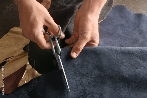 Man cutting leather in workshop