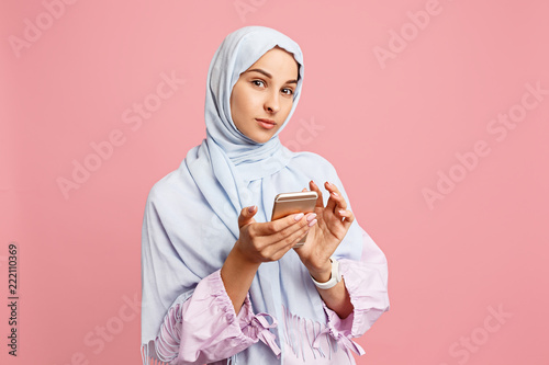 Happy Arab Woman In Hijab With Mobile Phone Portrait Of Smiling Girl Posing At Pink Studio Background Young Emotional Woman The Human Emotions Facial Expression Concept Front View Stock Photo Adobe
