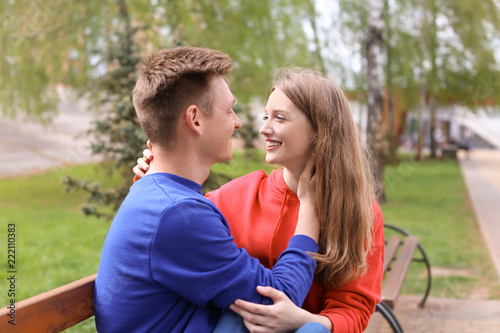 Happy young couple in park ...
