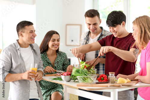 Friends cooking together in...