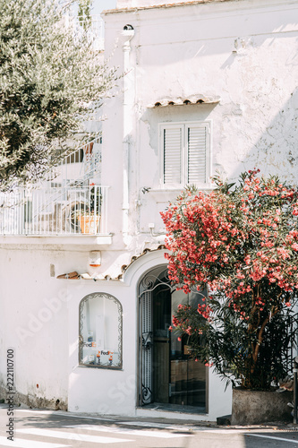 The coast of Positano, Amalfi in Italy. Panorama of the evening city and the streets with shops and cafes. Houses by the sea and the beach. Ancient architecture and temples