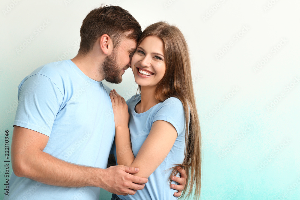 Happy young couple on color background - obrazy, fototapety, plakaty 