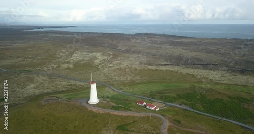 Beautiful aerial view of Reykjanes lighthouse in Iceland. Stunning Icelandic landscape. Drone flies during the daylight hours. Beautiful sunny summer day. The lighthouse sits on top of a hill. photo