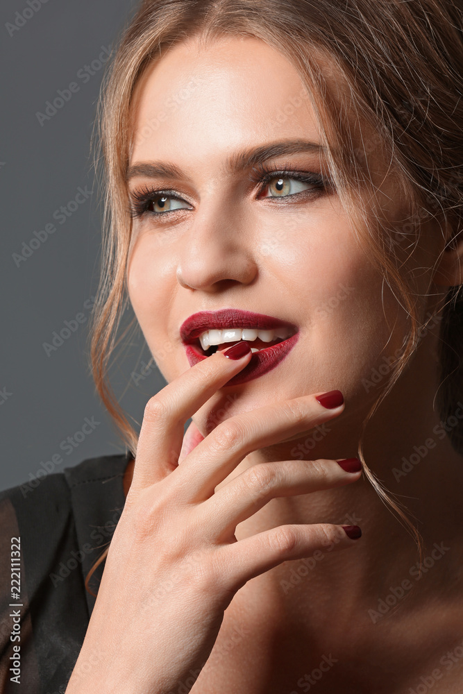 Fototapeta premium Fashionable young woman with beautiful manicure on grey background