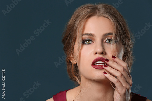 Fashionable young woman with beautiful manicure on color background