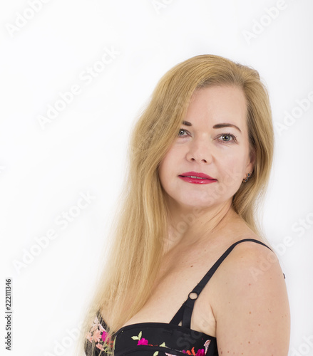 Beautiful blonde woman portrait in lingerie. 45 old woman close up on white background