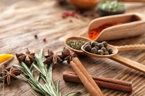 Composition with different spices on wooden background