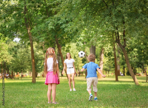 Happy family playing footba...