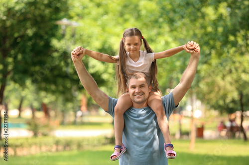 Happy father and daughter in green park