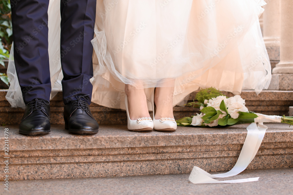 Happy wedding couple on stairs outdoors Happy wedding couple on stairs outdoors