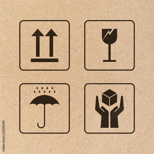 Black fragile sign and symbol on brown cardboard paper. Fragile symbol illustration.