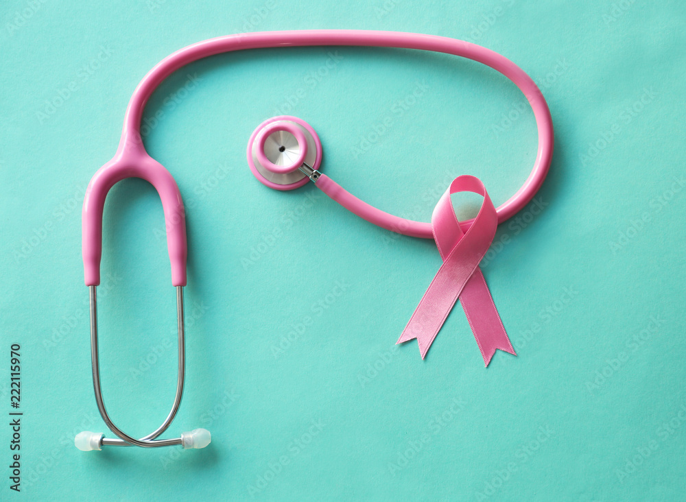Pink ribbon and stethoscope on color background. Breast cancer awareness concept