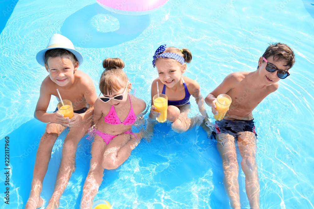 Cute children with glasses of juice in swimming pool on summer day - obrazy, fototapety, plakaty 