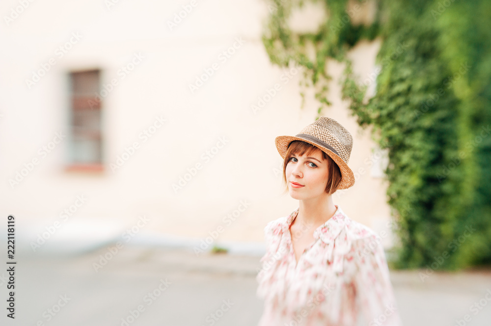 Portrait of a beautiful woman in a straw hat. Young girl. Summer time