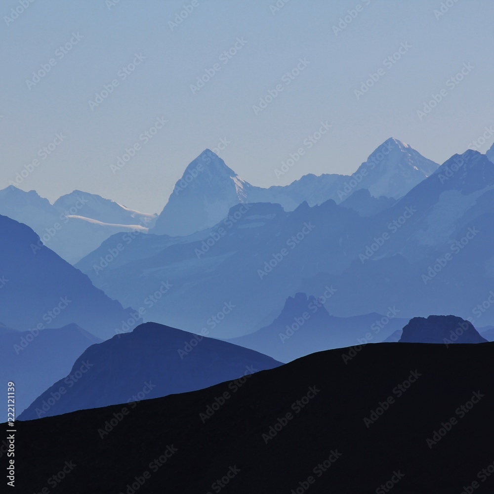 Mountain peaks of the Bernese Oberland at sunrise. View from Glacier 3000, Switzerland.
