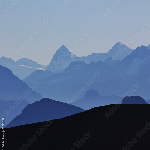 Mountain peaks of the Bernese Oberland at sunrise. View from Glacier 3000, Switzerland.
