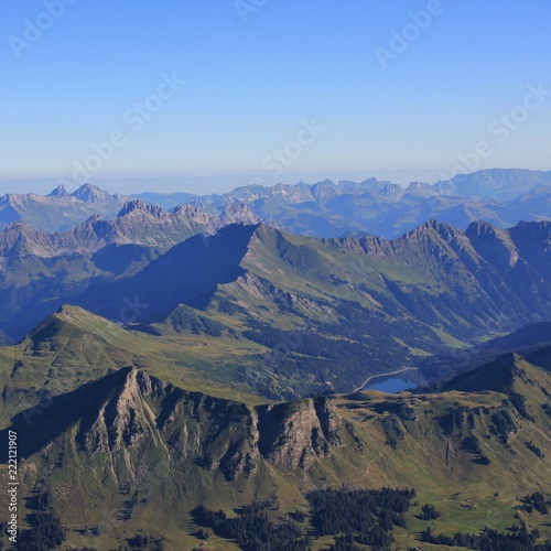 Lake Arnen and mountain ranges on a summer morning. View from Glacier 3000, Switzerland.