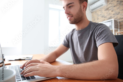 Handsome man working on lap...
