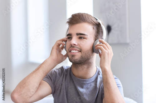 Handsome young man listenin...