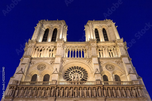 Facade of the Notre-Dame cathedral in the blue hour in Paris, France 