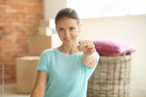 Young woman with key after ...