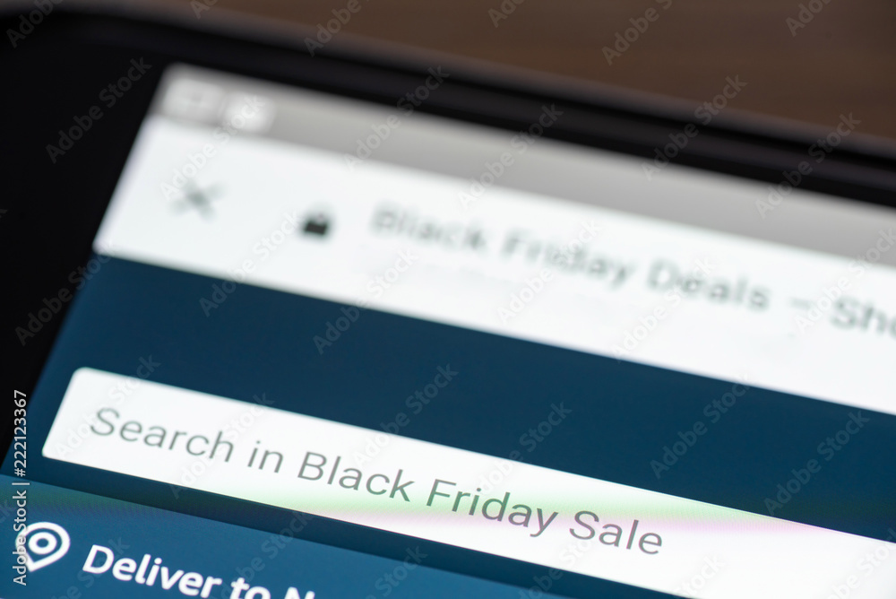 Black Friday Sale text in search box on shopping app on smartphone screen closeup