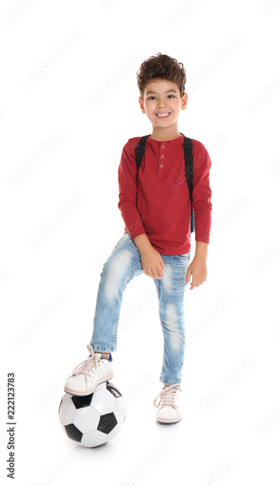 Playful little boy with soccer ball on white background