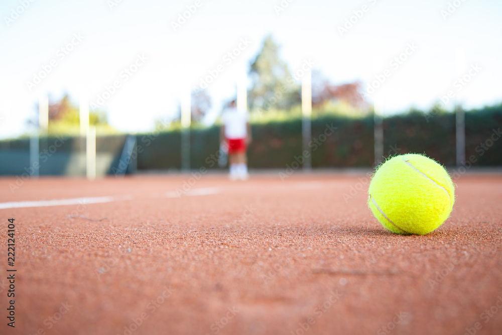 Tennis ball on the floor of a tennis court in a match in the shade. 