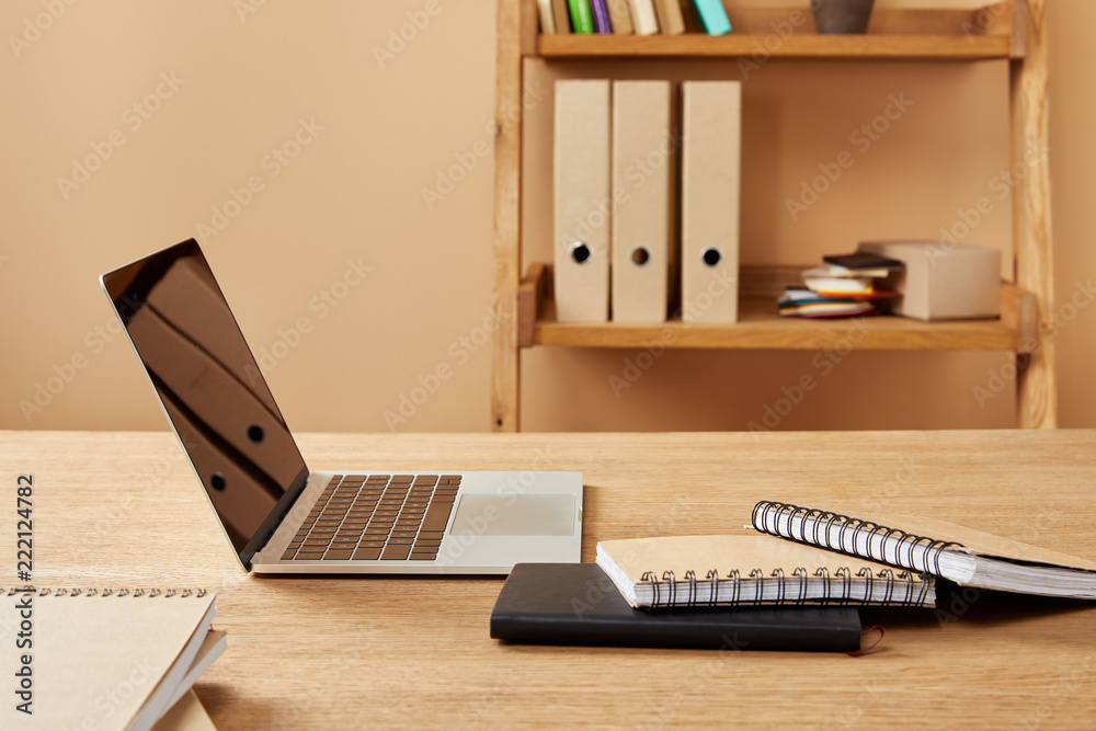 laptop and notebooks on wooden table at home laptop and notebooks on wooden table at home