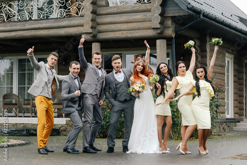 Fototapet .positive stylish guests at a wedding with a couple in love in the autumn on the
