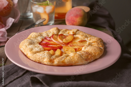 Delicious peach galette on plate photo