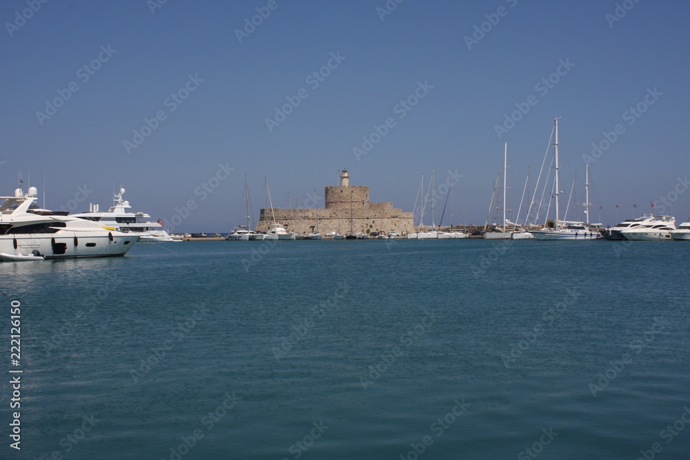 The Gate of Marina in Rhodes Island with fort and lighthouse