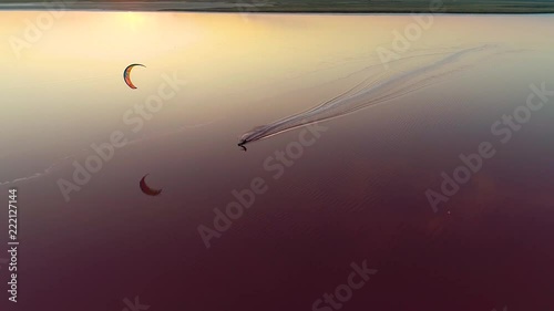 Aerial shooting of a kitesurfer in the middle of a pink lake photo