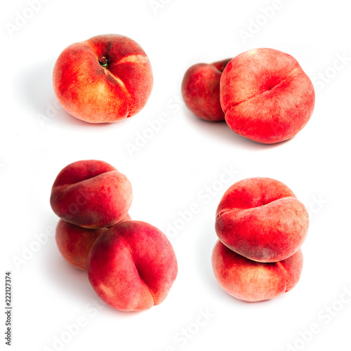 Saturn Peach isolated on white background. A set of flat peaches. Tree doughnut peaches in a pile.