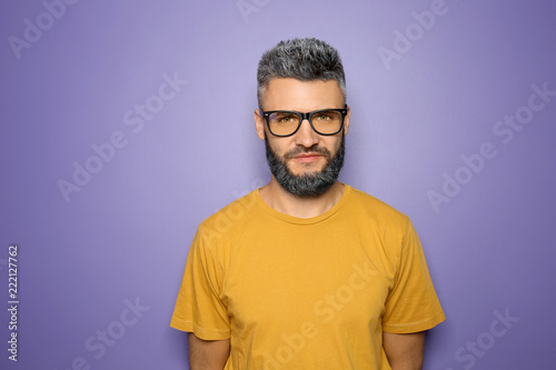 Εκτύπωση καμβά Portrait of handsome man with dyed hair and beard on color background